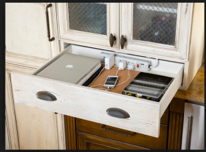 What a great use of space - a pull out charging station for electronics in the kitchen. 